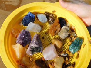 gemstones in yellow sieve